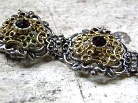 Close-up of filigree panel showing gold overlay and red garnet