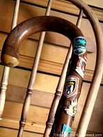 Curved handle and upper shaft showing multiple enamel badges including Berlin crest