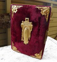 Front cover showing burgundy velour and ornate gilt brass fittings