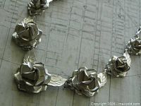 Close-up of sterling silver rose and leaf links