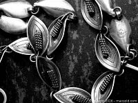 close-up of leaf links showing maker mark and texture