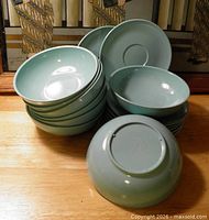 Stack of all sixteen sea-green melamine bowls