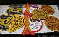 Group image of all eight vintage softball patches