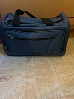 Dark blue Skyway duffel bag front view with handles and zip pocket