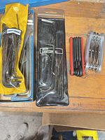 Overall view of five Allen wrench sets including two Craftsman packaged sets, loose set and two folding hex key tools