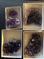 Five amethyst crystal clusters in four small white boxes