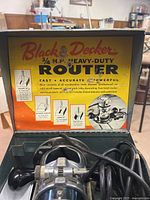 Lid of metal case showing Black & Decker 3/4 HP Heavy-Duty Router graphics