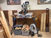Front view of Bosch miter saw on stand with accessories beneath