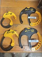 Four CableClamp PRO cable clamps on workbench surface