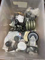 overview of bin showing various casters and hardware