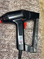 Left side view showing Craftsman branding, trigger handle, metal staple magazine, cord