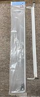 Packaged white curtain rod with hardware