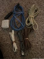 Group shot of five extension cords and outlet adapter