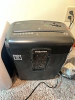 Front view of Fellowes 8MC5 shredder showing body, bin window and power cord