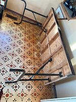 Underside view showing plywood frame and black metal folding legs of rectangular table