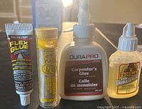 Four loose adhesive containers – Flex Glue, PC epoxy stick, DuraPro carpenter’s glue, Gorilla clear glue