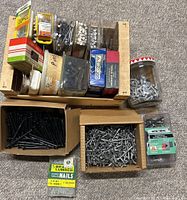 overview of tray with assorted fasteners, two bulk boxes, jar and packs