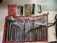 All hex key sets laid out on table including 25-piece roll and smaller sets