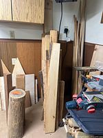 Stack of live edge boards standing vertically against wall