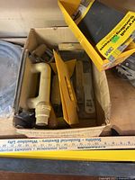 Overview of box with assorted drywall tools and 3M sanding screen box