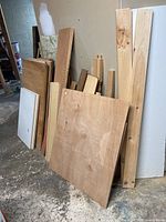 Front view of stacked plywood, pine boards, melamine panels