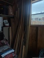 Full view of assorted wood boards leaned against wall