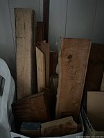 Front view of assorted hardwood boards and blocks in box