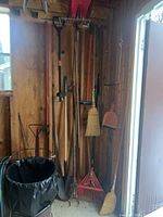 Group of hanging yard tools on wall