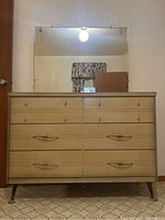 Front view of six-drawer dresser with mirror attached