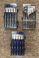 Three precision screwdriver sets in clear cases