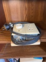 Overall view of modified electrical control unit showing outlet, rotary knob, and power cord