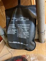 Back of bag with bilingual booster cable usage instructions