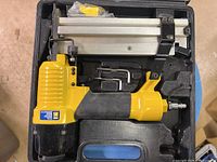 Nailer in open case with accessories visible