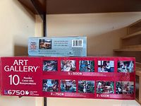 Front and side view of Art Gallery box and smaller puzzle box on shelf