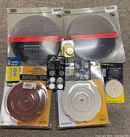 All items laid out: sanding discs, leather hone, slotted wheel, felt wheel, diamond wheel set, brass plates