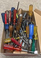Box of assorted screwdrivers showing quantity, handle styles and tips