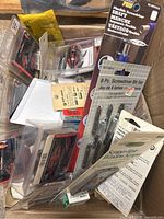Box full of various packaged small tools and hardware