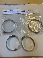 Four hose clamps, two packaged, two loose