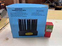 Boxed transfer punch set alongside red case number punch set