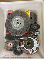 Top view of bin with multiple wire wheels and grinding discs, visible Walter HP disc