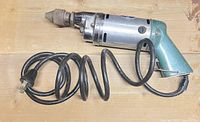Full view of vintage Hi-Power corded drill with coiled power cord