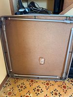 Table underside showing folding metal frame and legs