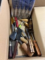 Box containing sealed blue-handled chisel set and assorted loose carving tools