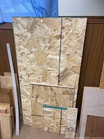 Stack of OSB panels leaning against wall