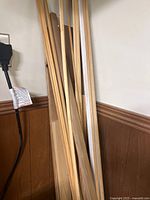 Long narrow wood pieces leaning against wall