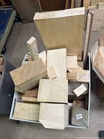 Top view of bin filled with assorted wood pieces of various sizes
