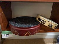 Steel tongue drum and GP tambourine on shelf