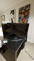 Front view of Insignia LCD TV on stand