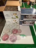Boxed wine glasses, sealed and open, with loose coloured cocktail glasses