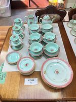 Stacked view of full 63-piece dinnerware set on table